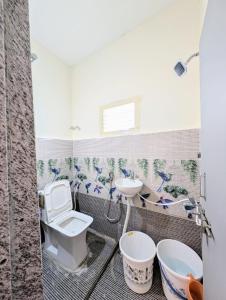 a bathroom with a toilet and a sink at Vista Home -Vizag homestay near City Hotspots ! AK in Jāmb