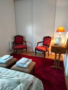 a room with two chairs and a table and a bed at Chambre d'hôtes Coeur de Maine in Angers +10 photos