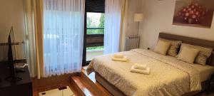 a bedroom with a bed with two towels on it at House Zaterini in Korenica