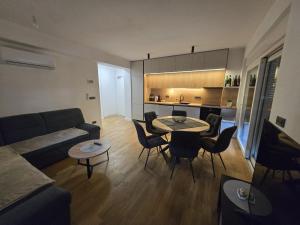 a living room with a couch and a table and chairs at Eis in Brodarica