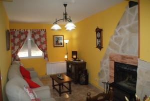 a living room with a couch and a fireplace at Dulce Encanto del Valle in Valle de Tabladillo