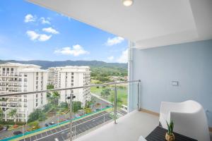 an apartment balcony with a view of a city at Upstay Brand New 3BR Viva Jaco Residences in Jacó