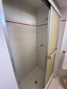 a shower with a glass door in a bathroom at PH en residencia privada con 2 puestos de estacionamiento in Caracas