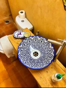 a blue and white bowl on a table in a bathroom at Riad Ayoub Fes in Fès