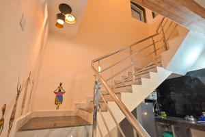 a spiral staircase in a house with a mural on the wall at ll EMPYREAN STAY ll MIRAGE CHALET ll 4BHK ll AC ll LARGEST POOL ll in Lonavala