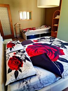 a bedroom with two beds with roses on them at COSY FLAT IN CENTRAL TIRANO - 60 seconds walk from Bernina Express Train station in Tirano
