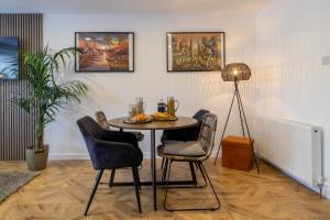 a dining room with a table and chairs at Modern 2-Bed Apt, Private Parking, Ayr Town Centre in Ayr +28 photos