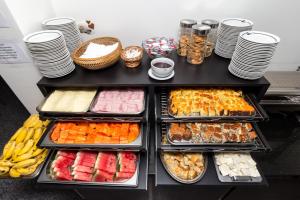 a buffet with many different types of food in trays at Hotel America do Sul in Sao Paulo