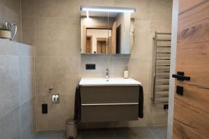 a bathroom with a sink and a mirror at Alpenruhe Werfenweng 