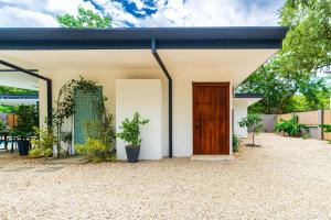 a house with a black roof and a door at Serenity Surf Villa in Playa Grande