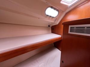 a small cabin in a boat with a window at Bião boat Apartment in Vila do Conde