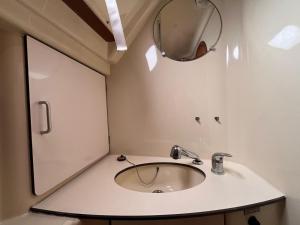 a bathroom with a sink and a mirror at Bião boat Apartment in Vila do Conde +23 photos
