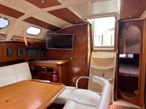 a dining room with a table and a tv in it at Bião boat Apartment in Vila do Conde