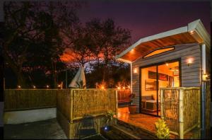 a small house with a porch at night at Casita VNV in Nosara