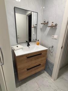 a bathroom with a sink and a mirror at Bonito apartamento de la playa in Villajoyosa