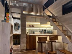 a kitchen with stairs leading up to a loft at Casita VNV in Nosara