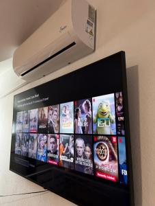 a television screen with a bunch of movies on it at Villa Maru in Bollullos de la Mitación +34 photos