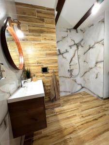 a bathroom with a sink and a shower at Leśna Ostoja  +14 photos