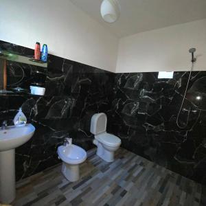 a bathroom with a toilet and a sink at Bovilla Canyon1 in Tirana +31 photos