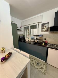 a kitchen with a table and a counter top at Casa AntoLeo - Borgo Casale Vicenza Centro in Vicenza