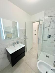 a white bathroom with a sink and a shower at Casa AntoLeo - Borgo Casale Vicenza Centro in Vicenza