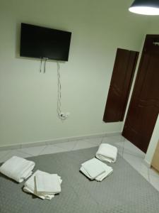 a room with two white towels and a flat screen tv at IRIS apartment in Sparti
