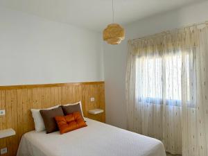 a bedroom with a white bed and a window at Farito Sunset in Gáldar