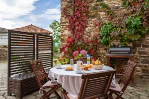 a table and chairs with fruit on a patio at La Quintana de Somao, Casa de Arriba in Somado