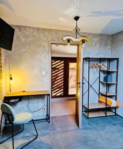 a room with a desk and a chair and a door at Très joli logement in Anould +19 photos