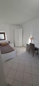 a bedroom with a bed and a tiled floor at SoLe Apartment in Campagnano di Roma