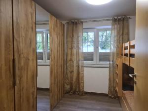 a bedroom with a bed and a window at Ferienwohnung Tannert, 3-Raum Wohnung mit eigener Sauna in Sebnitz +6 photos