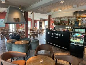 a restaurant with tables and chairs and a bar at Trosa Åda Krog Hotell & Konferens in Trosa