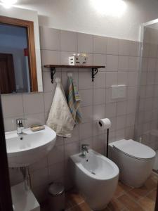 a bathroom with a sink and a toilet at Villa Marini in Trevignano Romano +20 photos