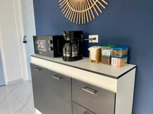a kitchen counter with a coffee maker and a microwave at Evolution Home in Las Flores