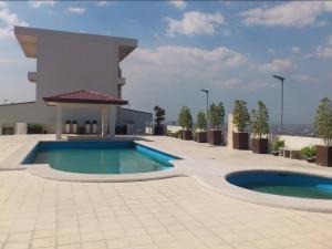a swimming pool on the roof of a building at Elly's Place in Quezon City