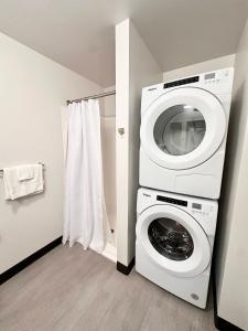 a laundry room with a washer and dryer in it at Deer District Studio Apt - One Block from Fiserv and Baird in Milwaukee +13 photos