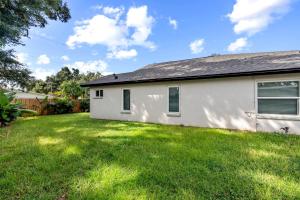 a house with a green yard in front of it at Staycation Station-Busch Gardens-Adventure Island-USF-Ampitheater-YBOR in Tampa