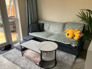 two stuffed animals sitting on a couch in a living room at The Cottontail - Modern Private Room With Breakfast - Tamworth in Tamworth