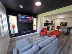 a living room with a couch and a flat screen tv at The Walkout at the Ravine in Edmonton