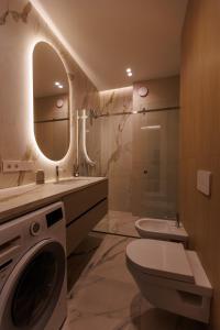 a bathroom with a sink toilet and a mirror at Modern Luxury Apartment 3 Inima Chisinaului in Chişinău +21 photos
