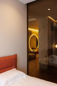 a bedroom with a bed and a mirror at Modern Luxury Apartment 3 Inima Chisinaului in Chişinău
