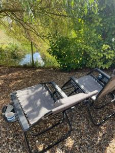 a folding chair sitting next to a bench at Mustard Pot Cottage in Eye