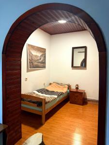 a bed in a room with an archway at Serana Stays in Peje +13 photos