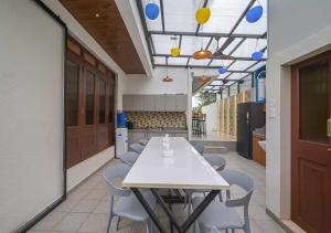 a cafeteria with a table and chairs and a kitchen at 5BHK Villa With Pool & Theater Room in Malavli