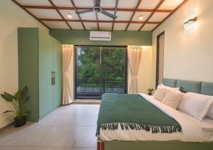 a bedroom with a bed and a large window at 5BHK Villa With Pool & Theater Room in Malavli +22 photos