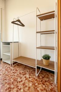 a room with two bunk beds and a plant at Pietra Ligure Sea View Parking & Bike Box in Pietra Ligure