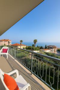 a balcony with chairs and a view of the ocean at Pietra Ligure Sea View Parking & Bike Box in Pietra Ligure +17 photos