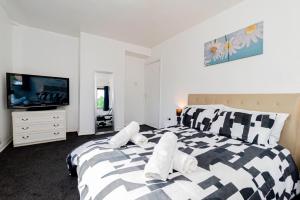 En eller flere senge i et værelse på The Oak 3 Bedroom House