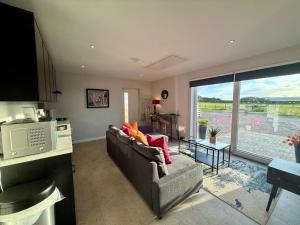 a living room with a couch and a large window at Star Scape in Markinch +8 photos