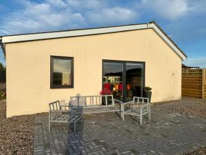 a building with two benches in front of it at Star Scape in Markinch